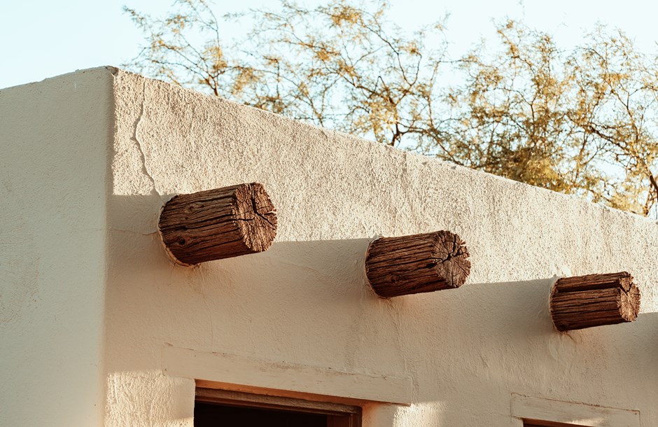 The roof of a building with three wooden barrels on top of it