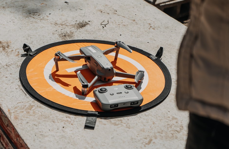 Drone and controller on a landing circle on concrete