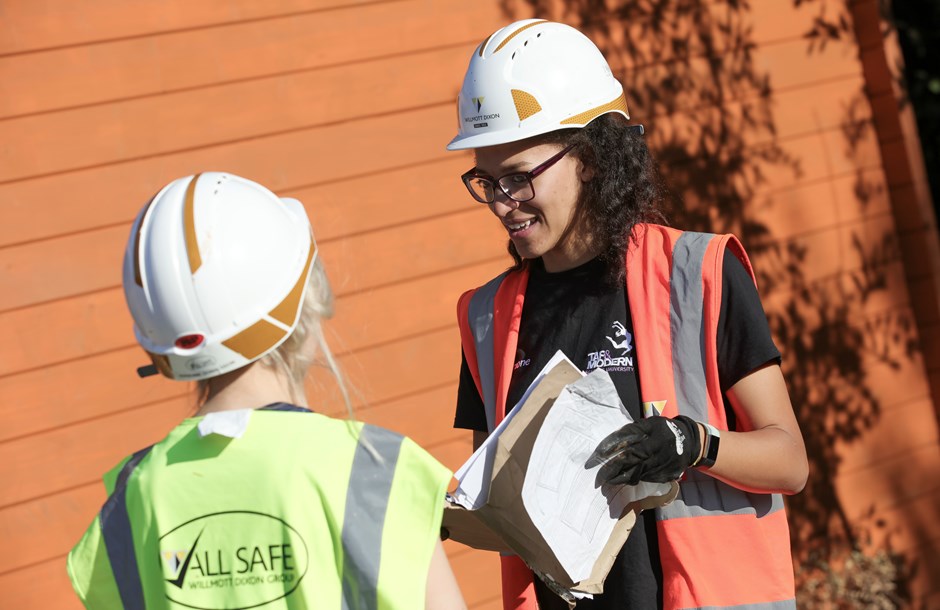 Two female construction workers in hard hats and Hi Vis vests
