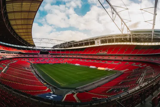 View of inside of Wembley Stadium taking from the corner of the stadium, showing rows of seats