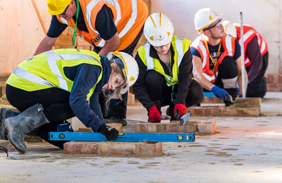 Apprentice bricklayers undertaking a task